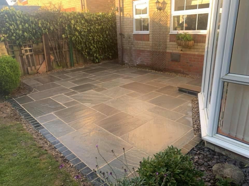 Detail of patio edging and boundary fencing installation