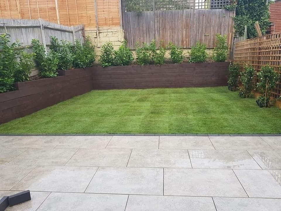 Integrated landscaping with raised beds and timber features